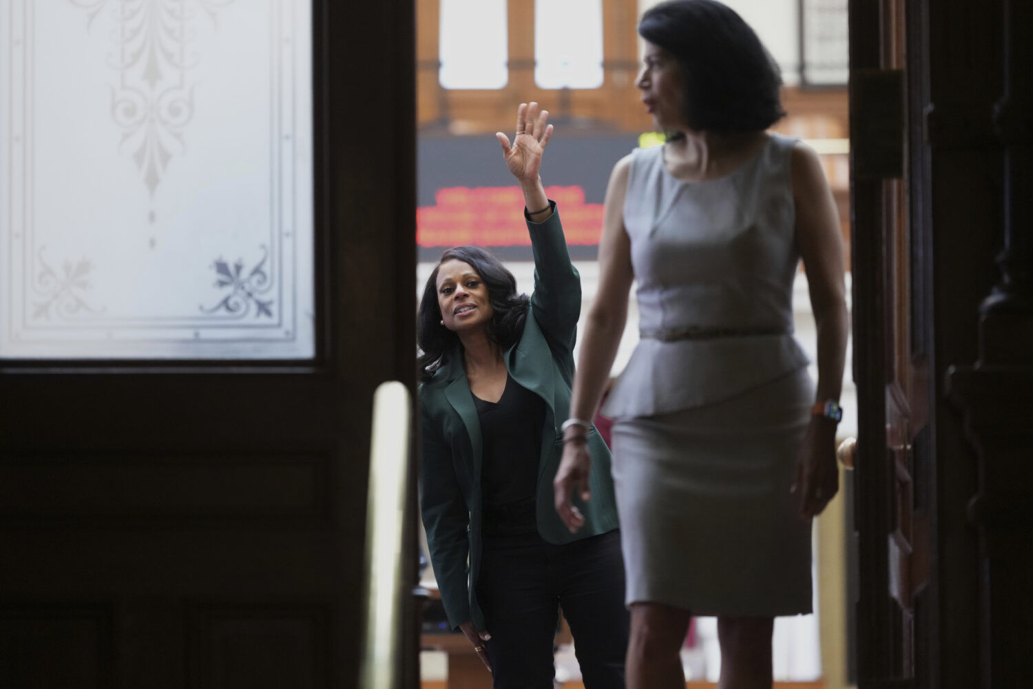 Texas state Rep. Nicole Collier, left, waves past Texas state Sen. Carol Alvarado, right, to suppor...