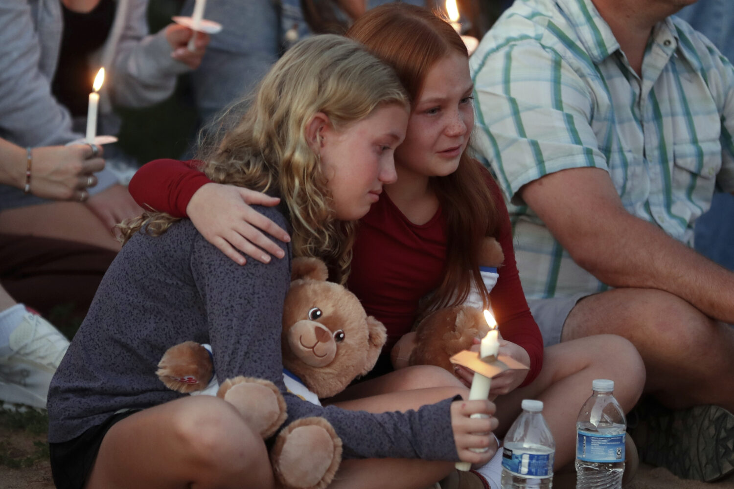 People gather at a vigil at Lynnhurst Park after a shooting at the Annunciation Catholic School, We...
