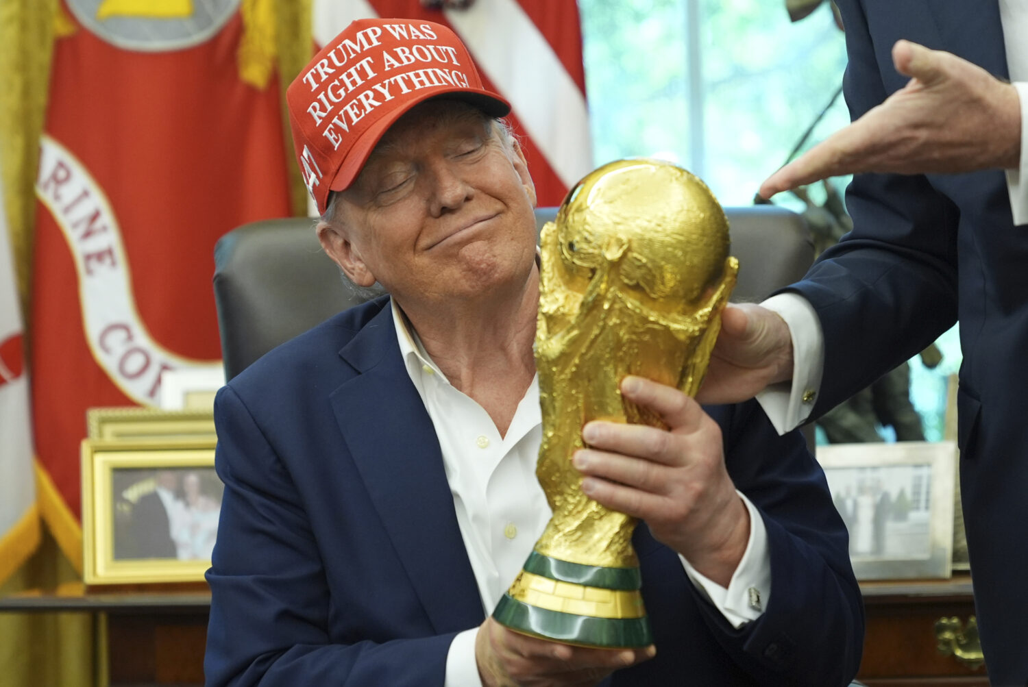 President Donald Trump holds the FIFA World Cup Winners Trophy during an announcement in the Oval O...