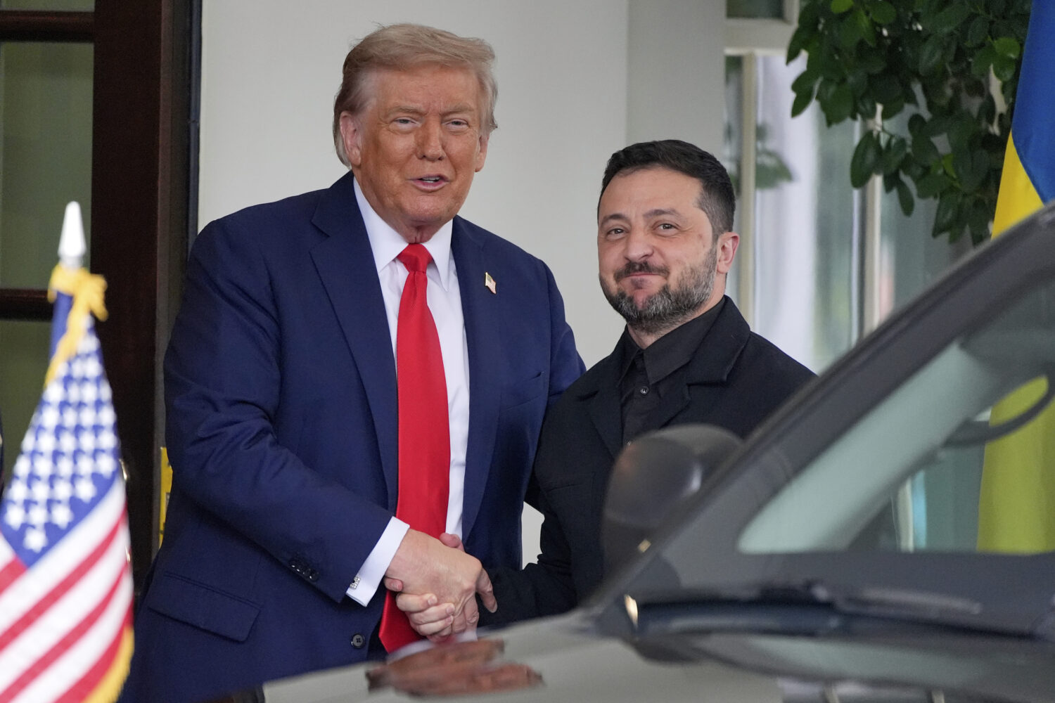 President Donald Trump, left, greets Ukraine's President Volodymyr Zelenskyy as he arrives at the W...