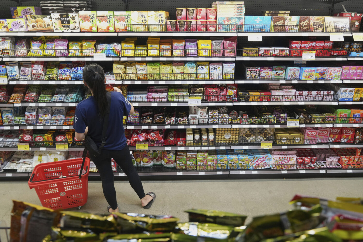 FILE - A customer buys Chinese made ginger candy at 99 Ranch Market, an Asian grocery store in Los ...