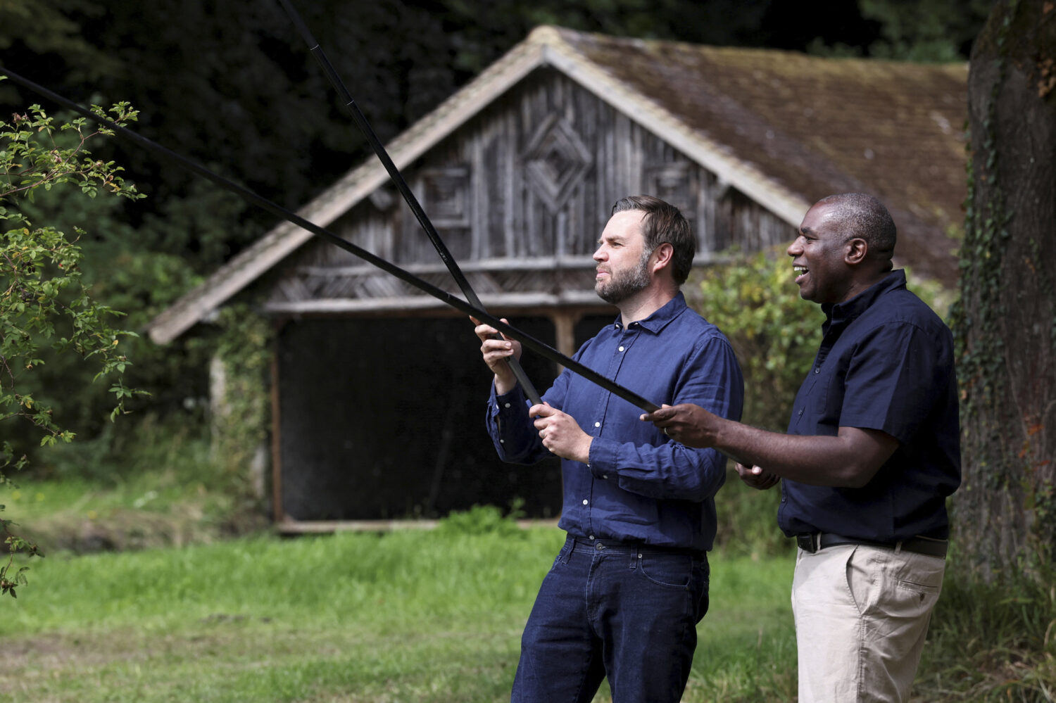 Vice President JD Vance, left, fishes with Britain's Foreign Secretary David Lammy in a lake in the...
