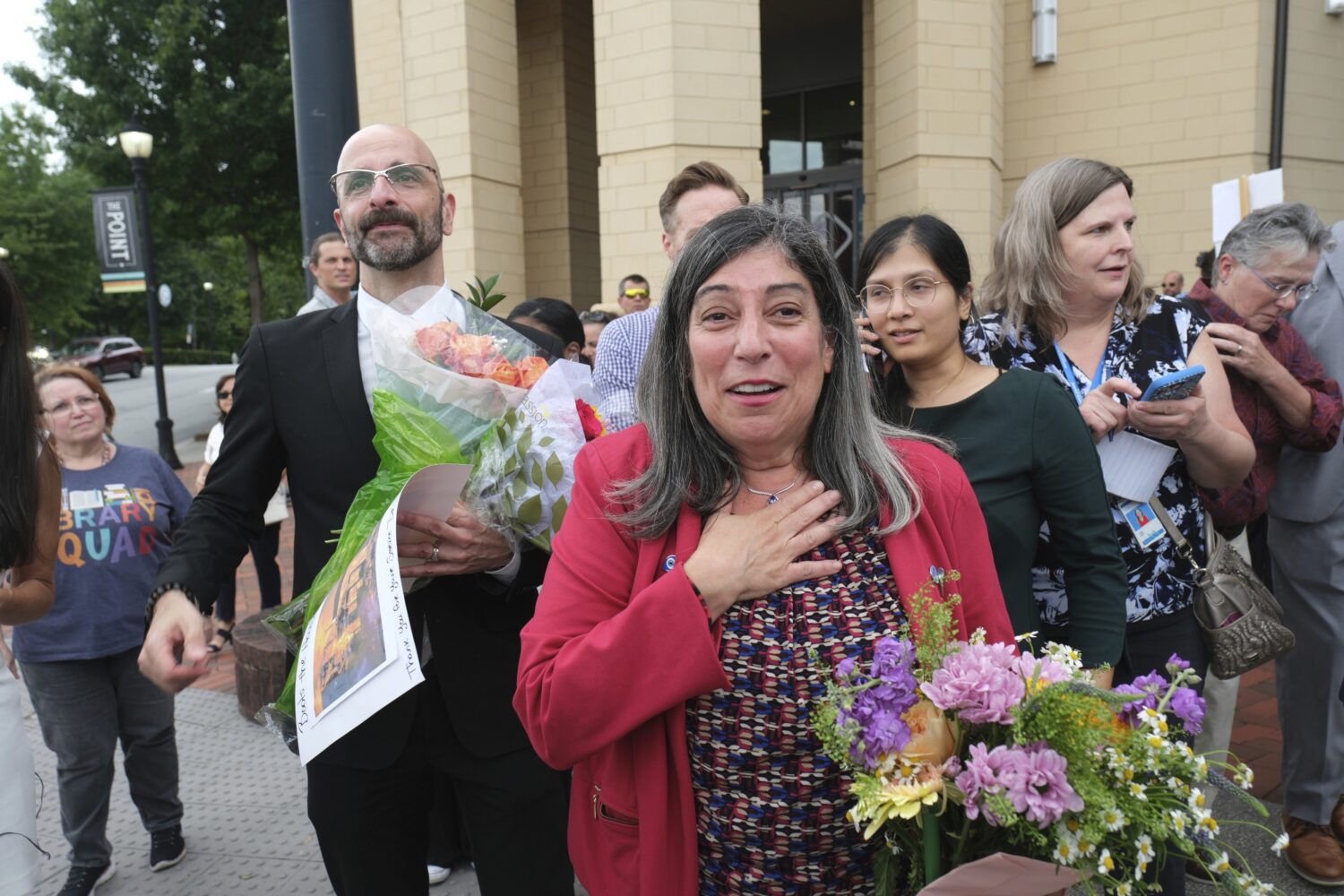 Dr. Demetre Daskalakis, left, and Dr. Debra Houry is greeted by friends as workers and supporters r...