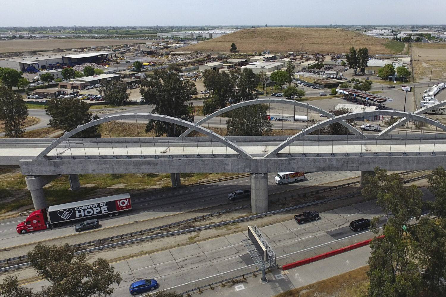 FILE - Vehicles pass underneath the Cedar Viaduct, designed to take high-speed trains over Cedar an...