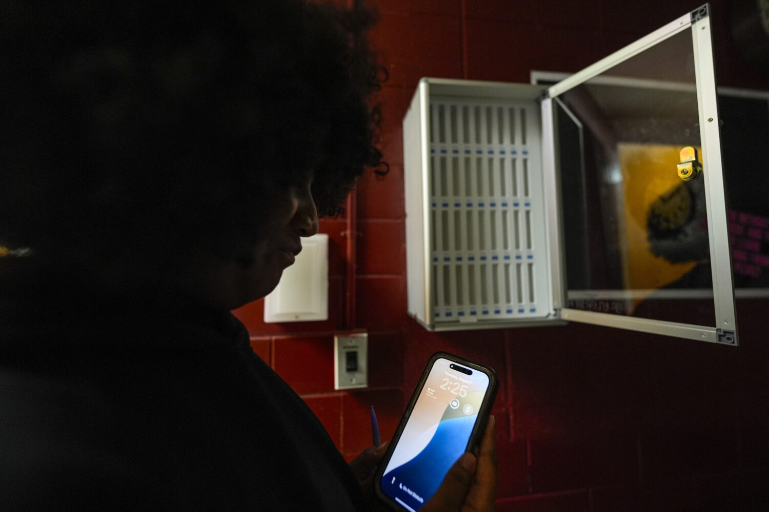 Student Audreanna Johnson views her cell phone near a cell phone locker at Ronald McNair Sr. High S...