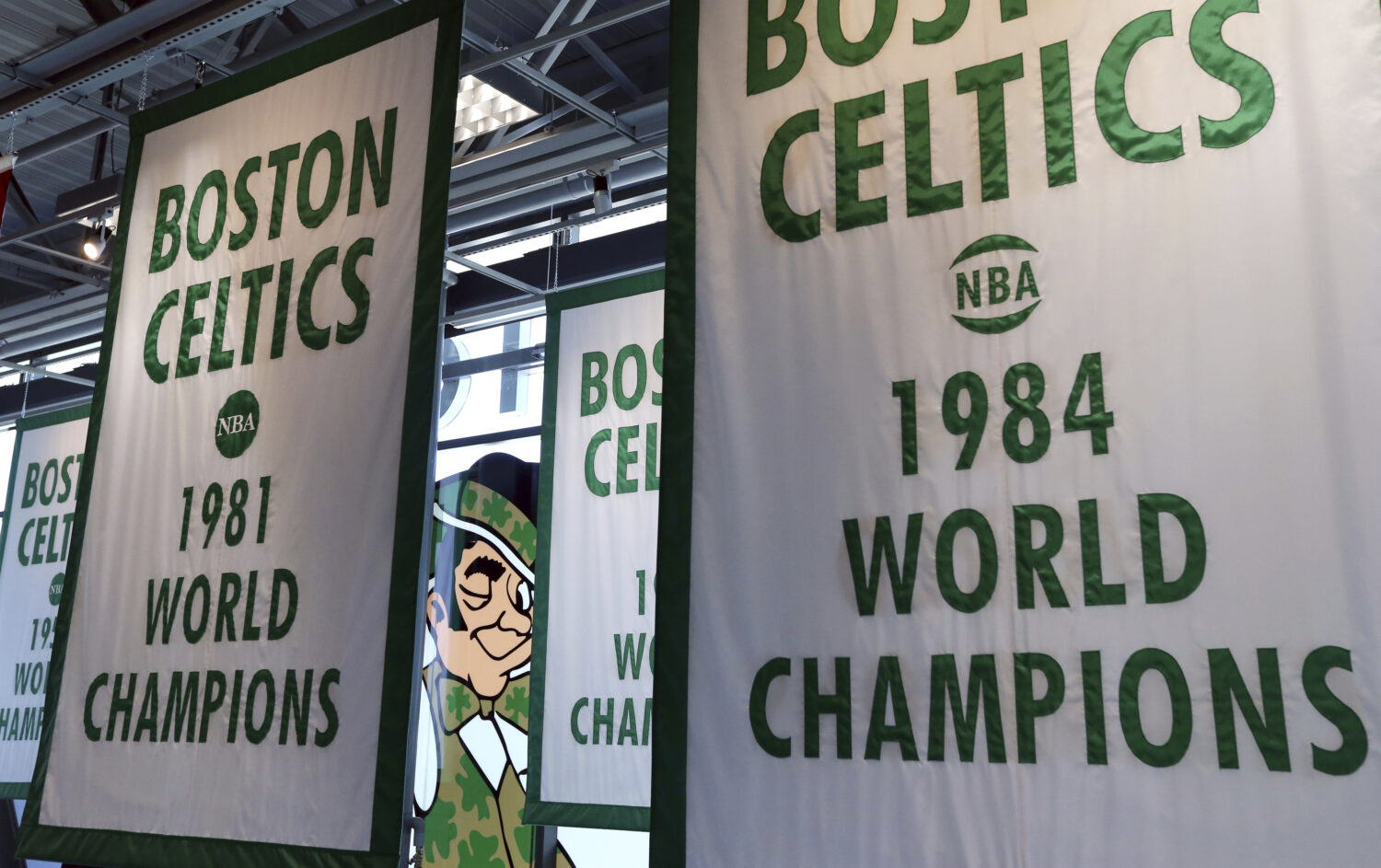 FILE - Lucky the Leprechaun, the Boston Celtics team logo, peers out from in between Celtics champi...