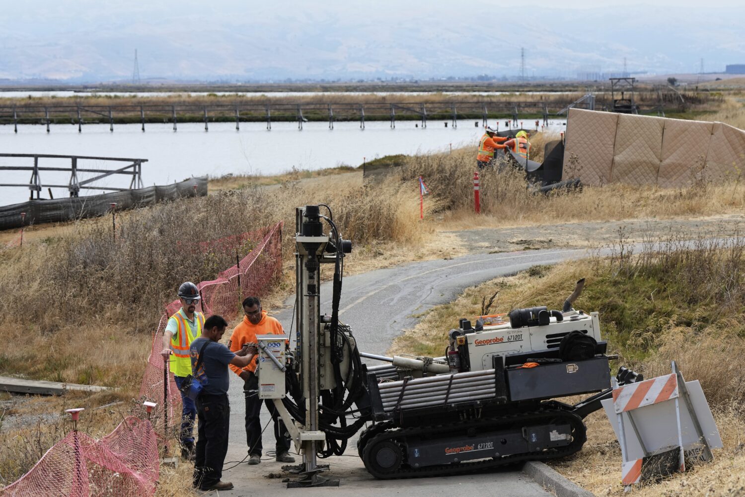 Crew members work on the Pond A2W site of the South Bay Salt Pond Restoration Project, Thursday, Ju...