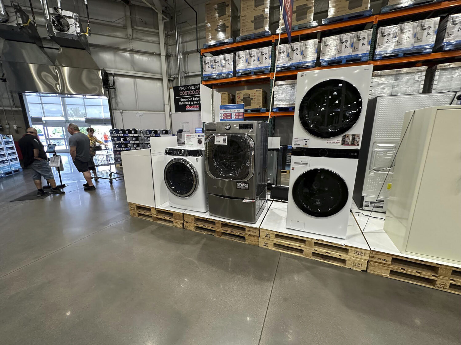 Washers stand on display near the entrance to a Costco warehouse Tuesday, July 8, 2025, in Sheridan...