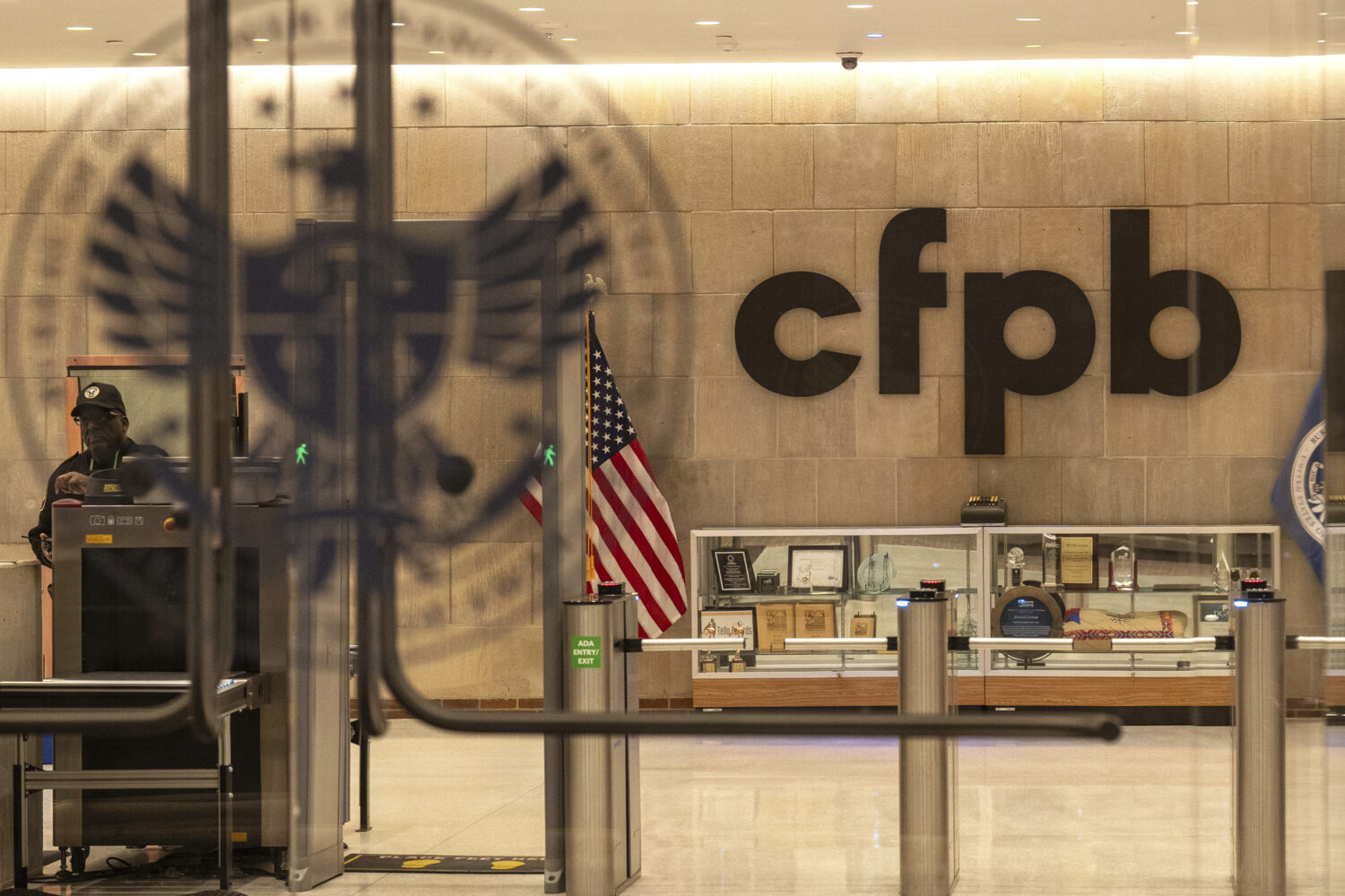 FILE - A security officer works inside of the Consumer Financial Protection Bureau (CFPB) building ...