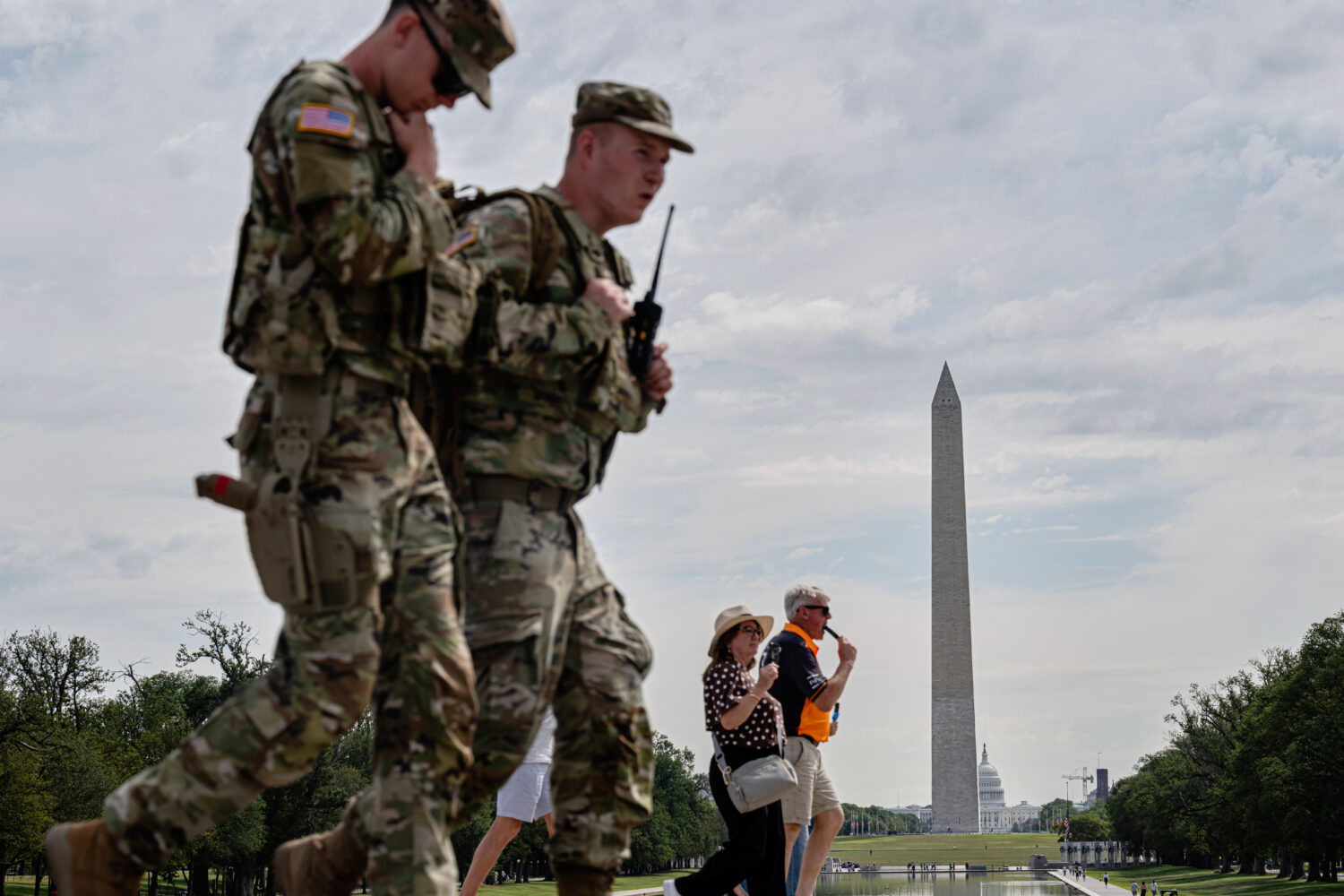 Visitors and members of the U.S. National Guard walk near the Lincoln Memorial, Thursday, Aug. 28, ...