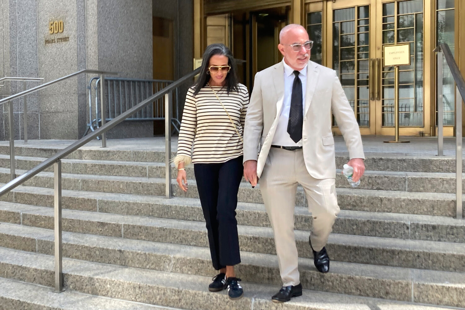 Prominent Miami defense attorney David Macey and his wife leave the Manhattan federal court Thursda...