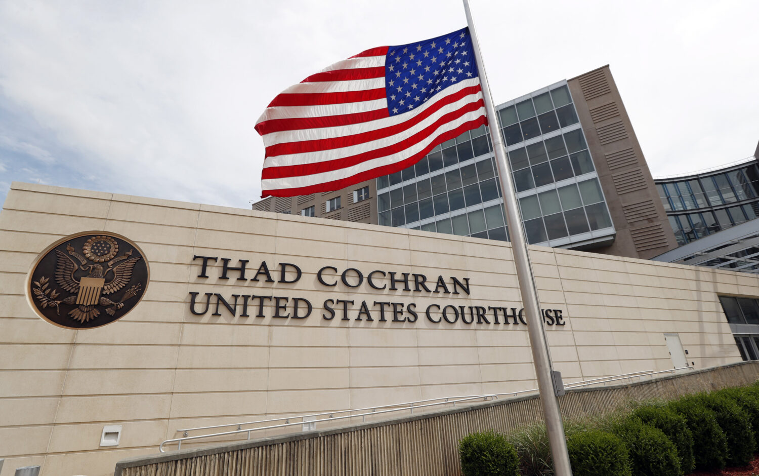FILE - An American flag flies at half-staff outside the Thad Cochran United States Courthouse in do...