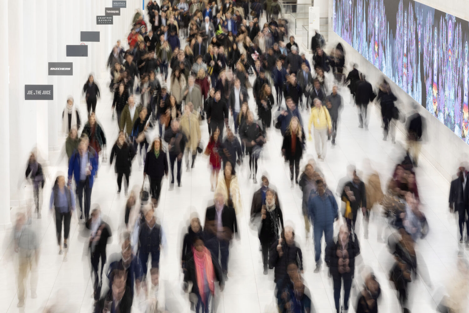 FILE - Commuters walk along a corridor in the World Trade Center, Monday, Nov. 18, 2019 in New York...