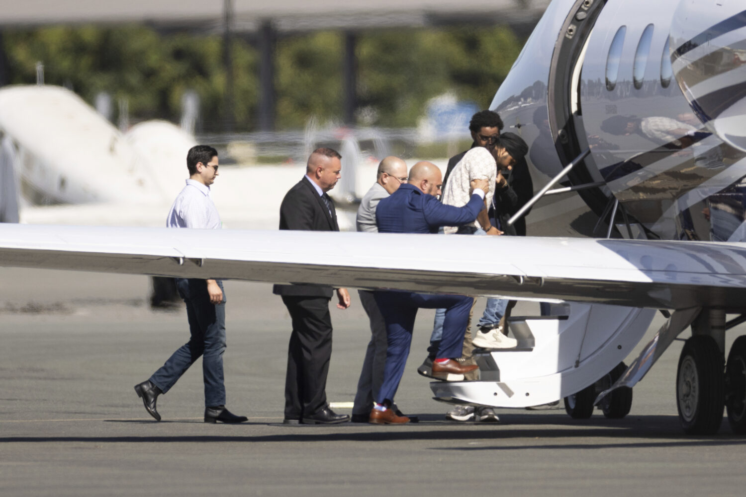 Harjinder Singh is escorted onto an airplane by Florida Lt. Gov. Jay Collins and law enforcement on...