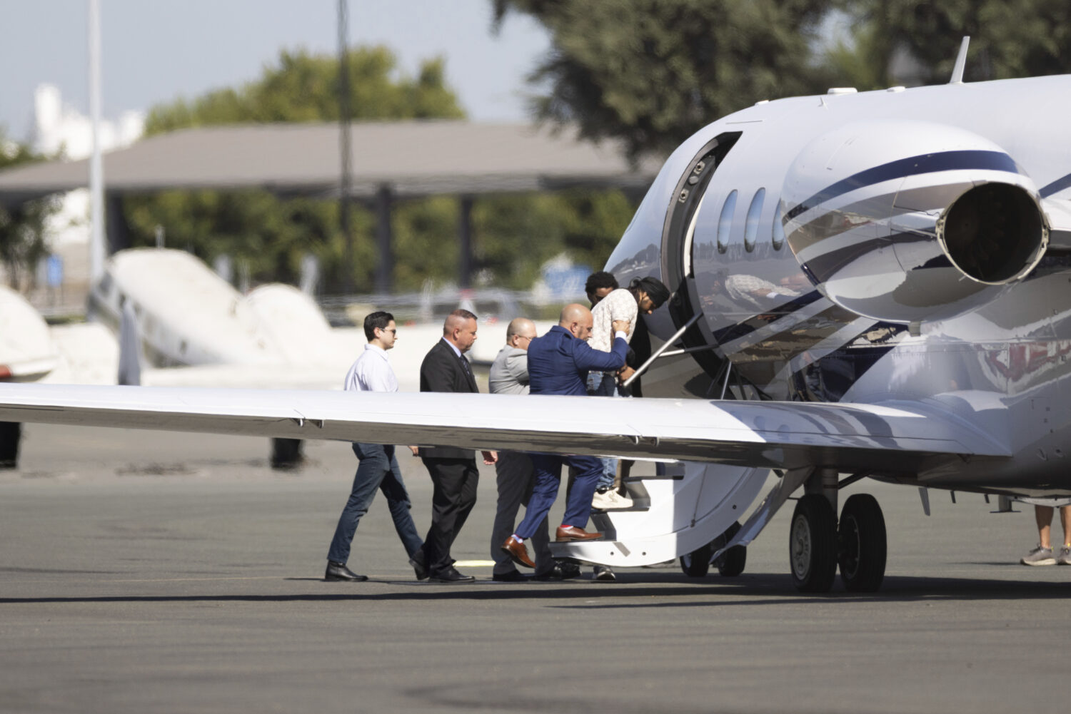 Harjinder Singh is escorted to an airplane by Florida Lt. Gov. Jay Collins and law enforcement on T...