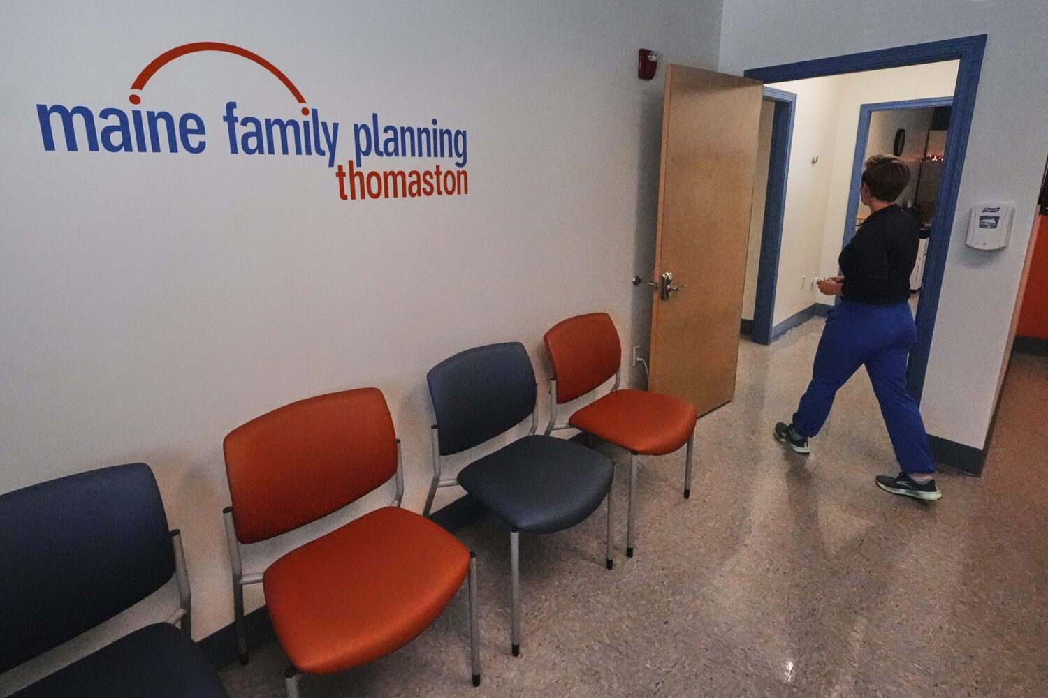 FILE - Vanessa Shields-Haas, a nurse practitioner, walks from the lobby toward the examination room...
