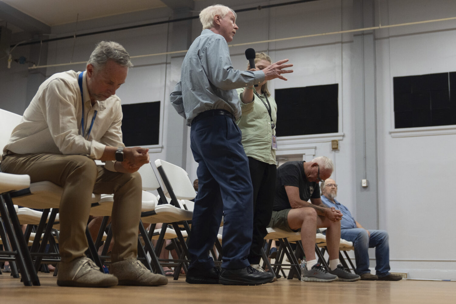 People ask questions as Sen. Ron Wyden, D-Ore., holds a town hall meeting Friday, July 25, 2025, in...