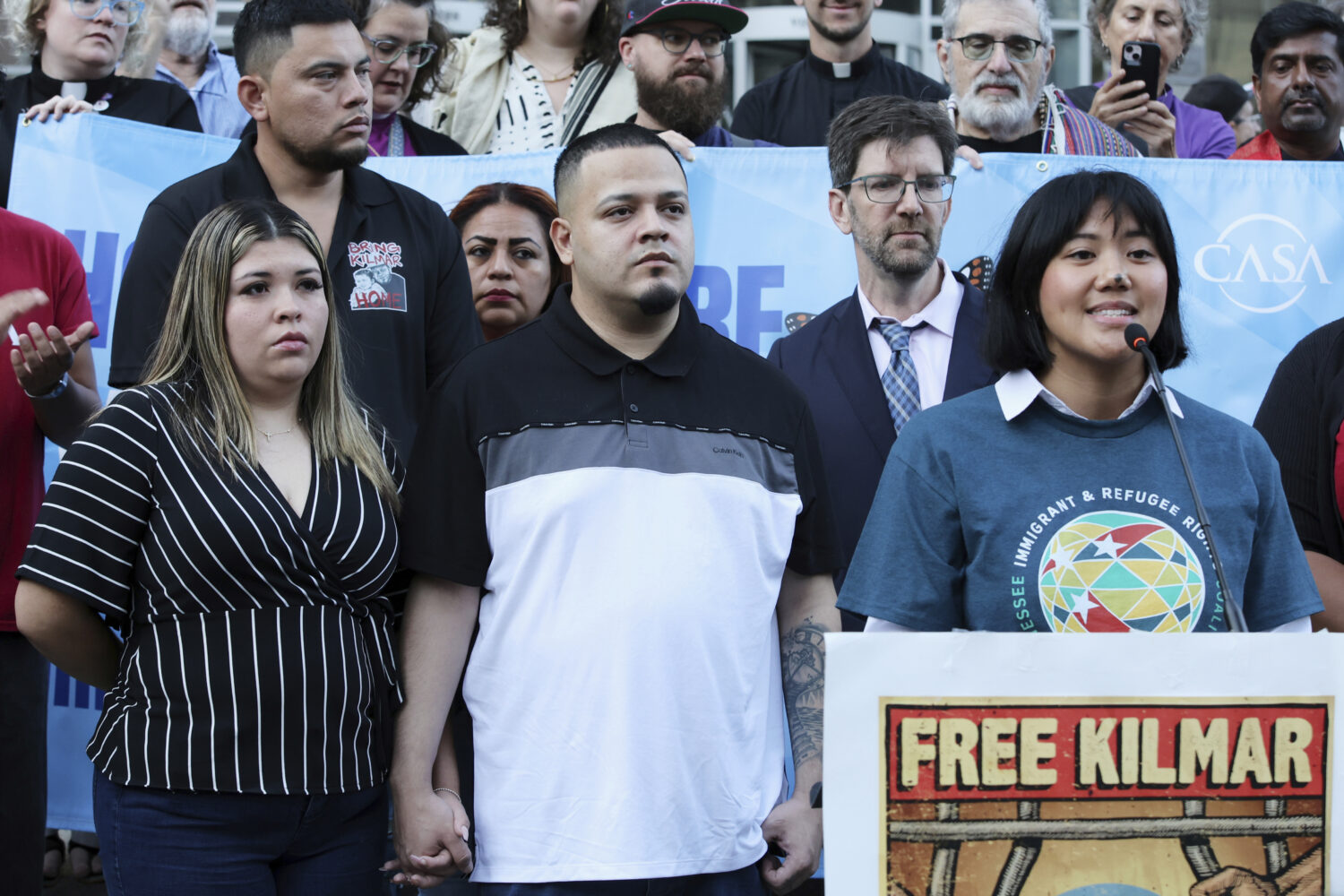 Jennifer Vasquez Sura, front left, wife of Kilmar Abrego Garcia, attends a protest rally at the Imm...
