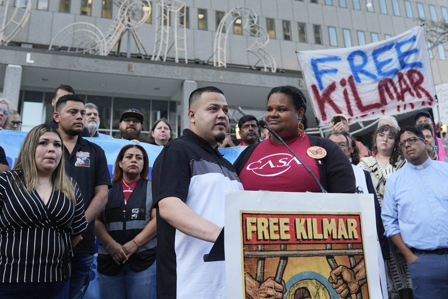 Jennifer Vasquez Sura, front left, wife of Kilmar Abrego Garcia, attends a protest rally at the Imm...