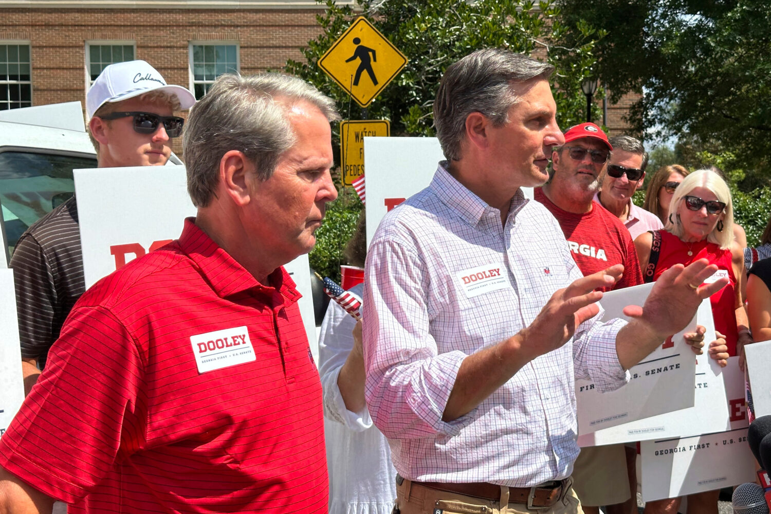 Republican U.S. Senate candidate Derek Dooley speaks, accompanied by Georgia Gov. Brian Kemp, foreg...