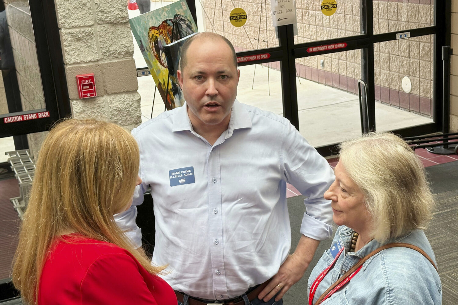 FILE - Georgia Attorney General Chris Carr, center, speaks to a delegate at the Georgia Republican ...