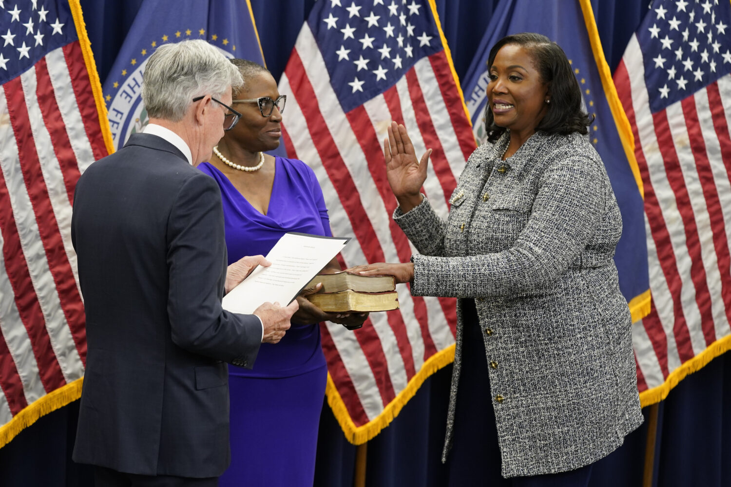 FILE - Lisa Cook, right, takes the oath of office to become a member of the Federal Reserve Board, ...