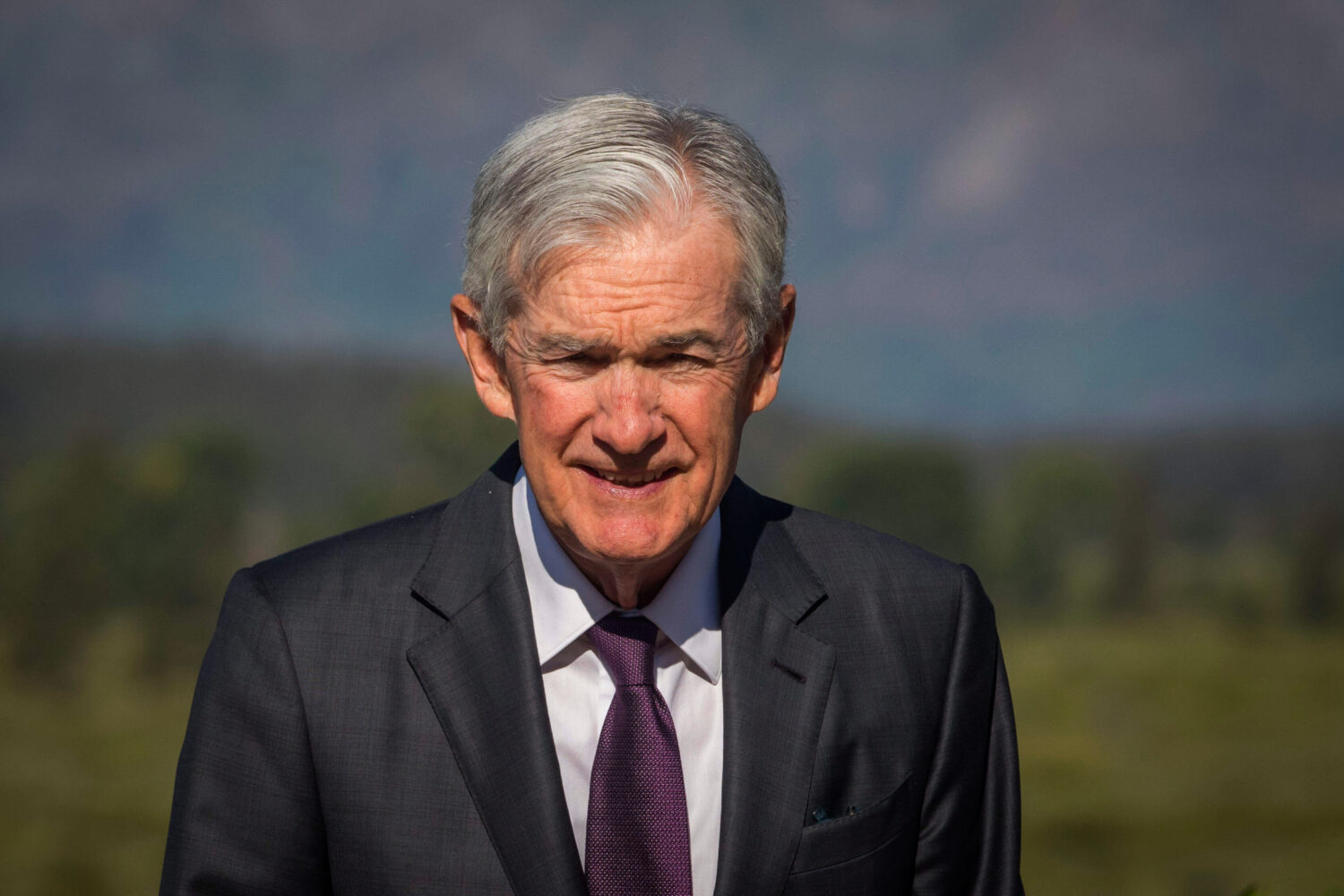 Federal Reserve Chairman Jerome Powell walks outside of Jackson Lake Lodge during a break at the Ja...