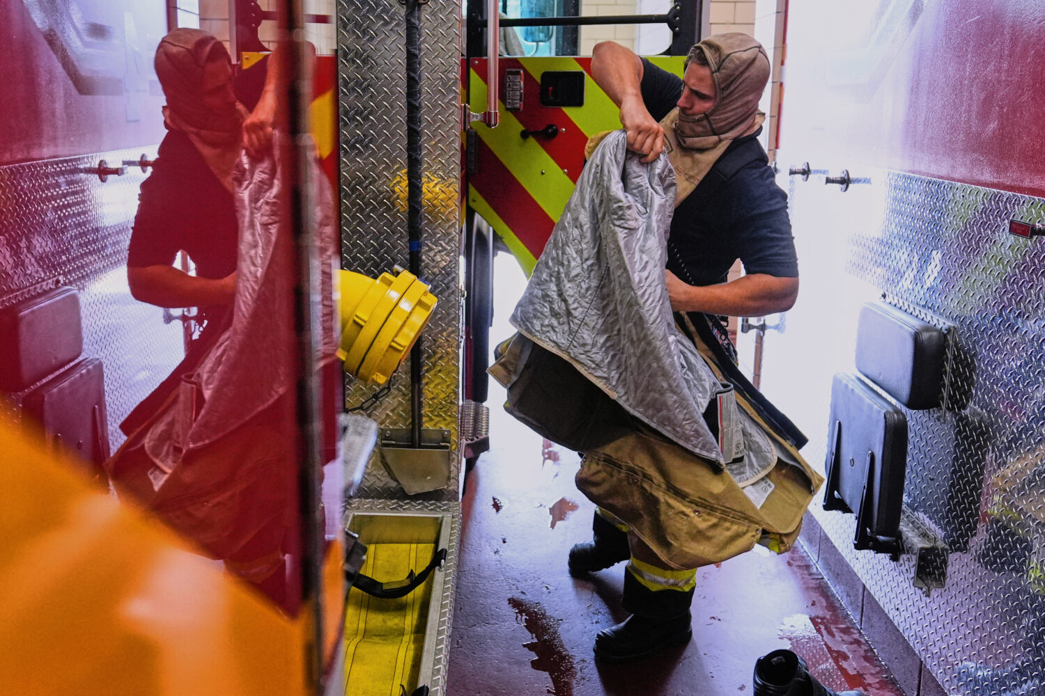 Firefighter Brendan Dyer suits up in recently issued non-PFAS turnout gear at Fire Station 4 in Eas...