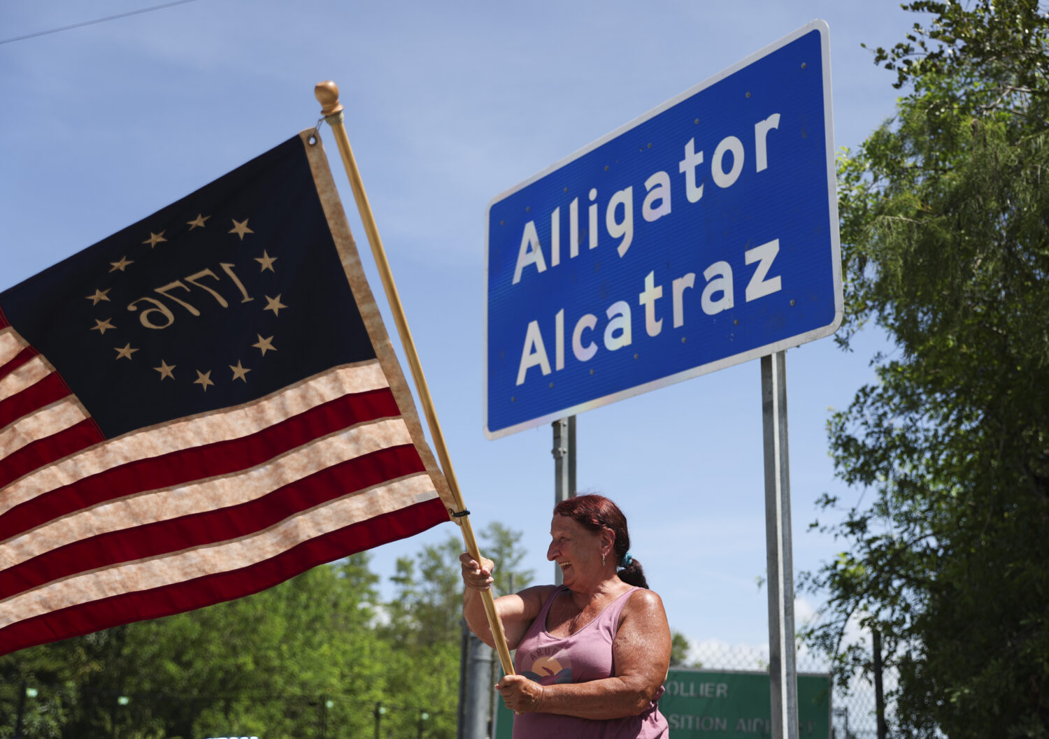 FILE - Rana Mourer waves an American flag outside of the Dade-Collier Training and Transition facil...
