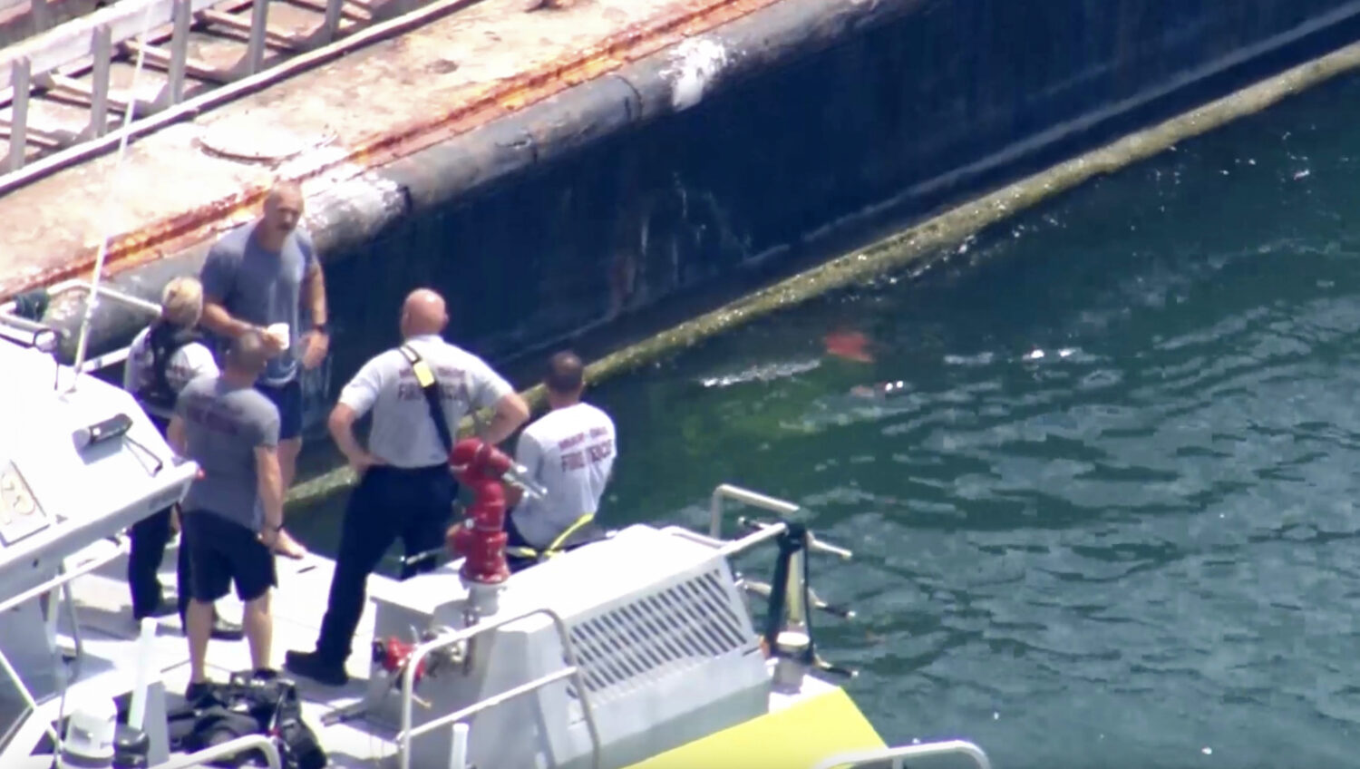 This image taken from video provided by WSVN-TV shows Miami-Dade Fire Rescue and others in a boat a...