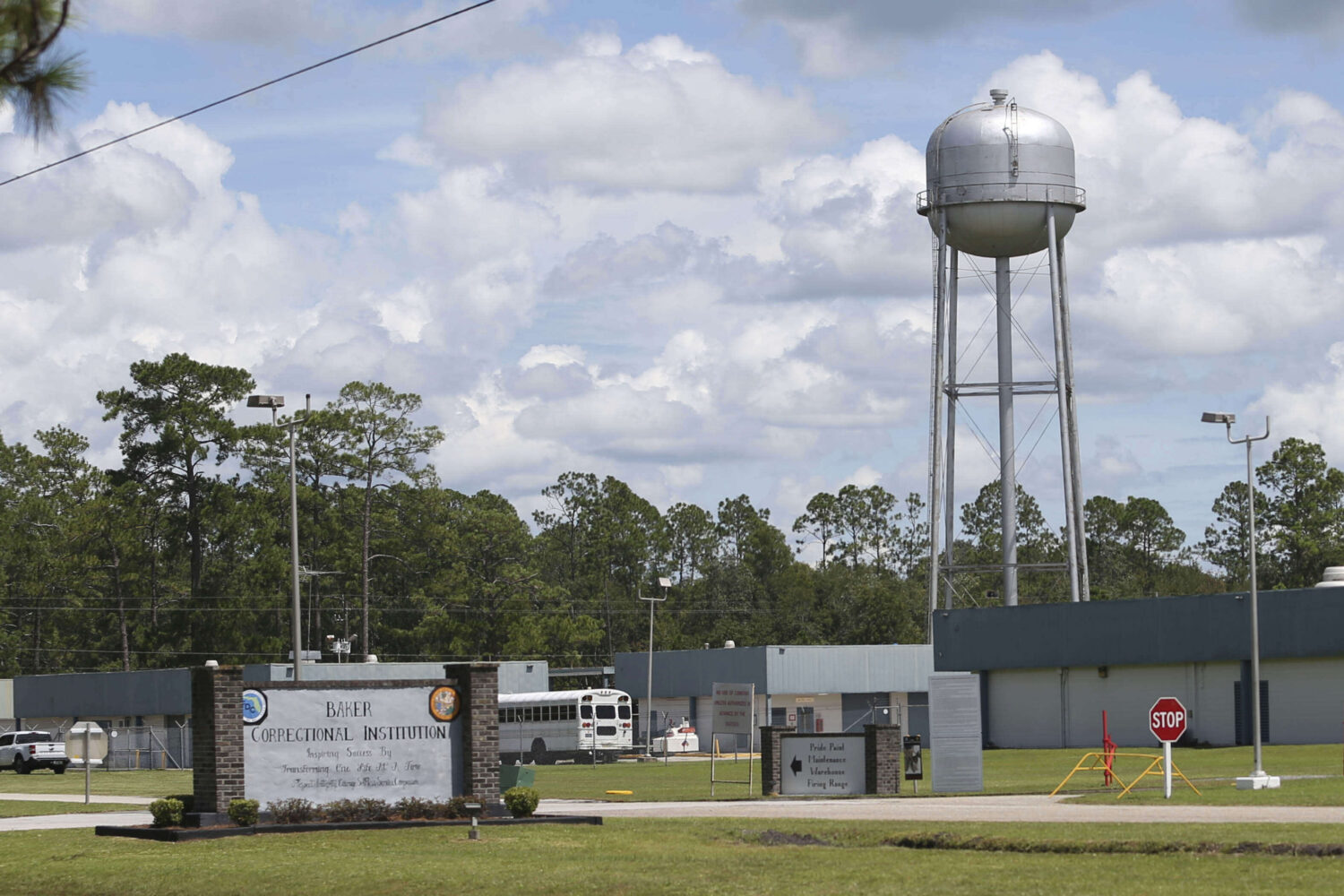 A sign marks the entrance to the Baker Correctional Institution, Sanderson, Fla., Thursday, Aug. 14...