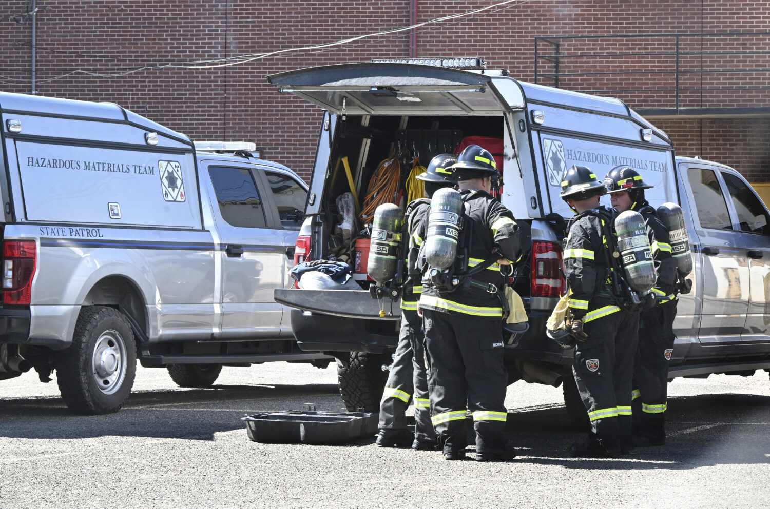 Members of the Colorado State Highway Patrol hazmat team get ready to enter the Davis Mortuary, Thu...