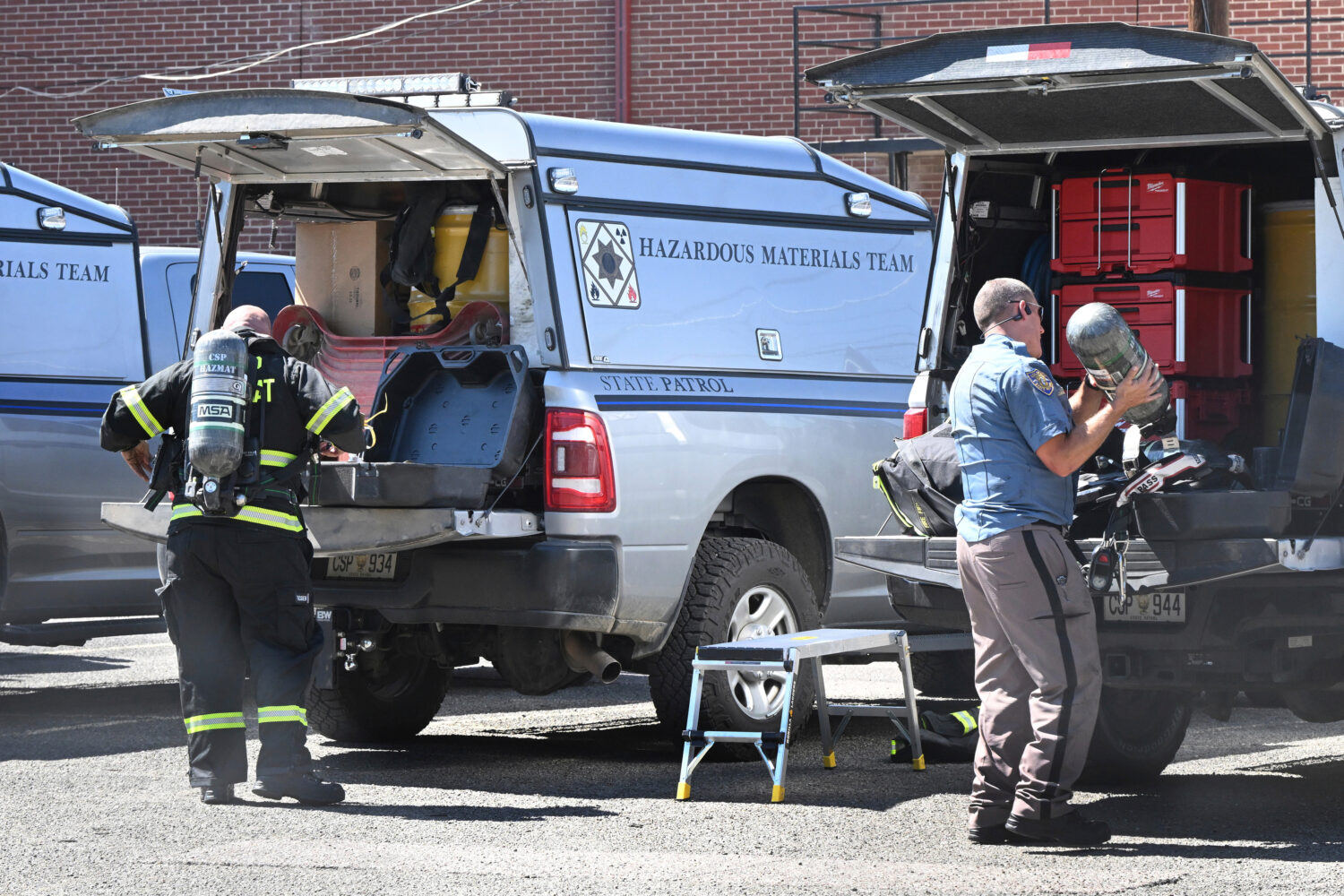 Members of the Colorado State Highway Patrol hazmat team get ready to enter the Davis Mortuary, Thu...