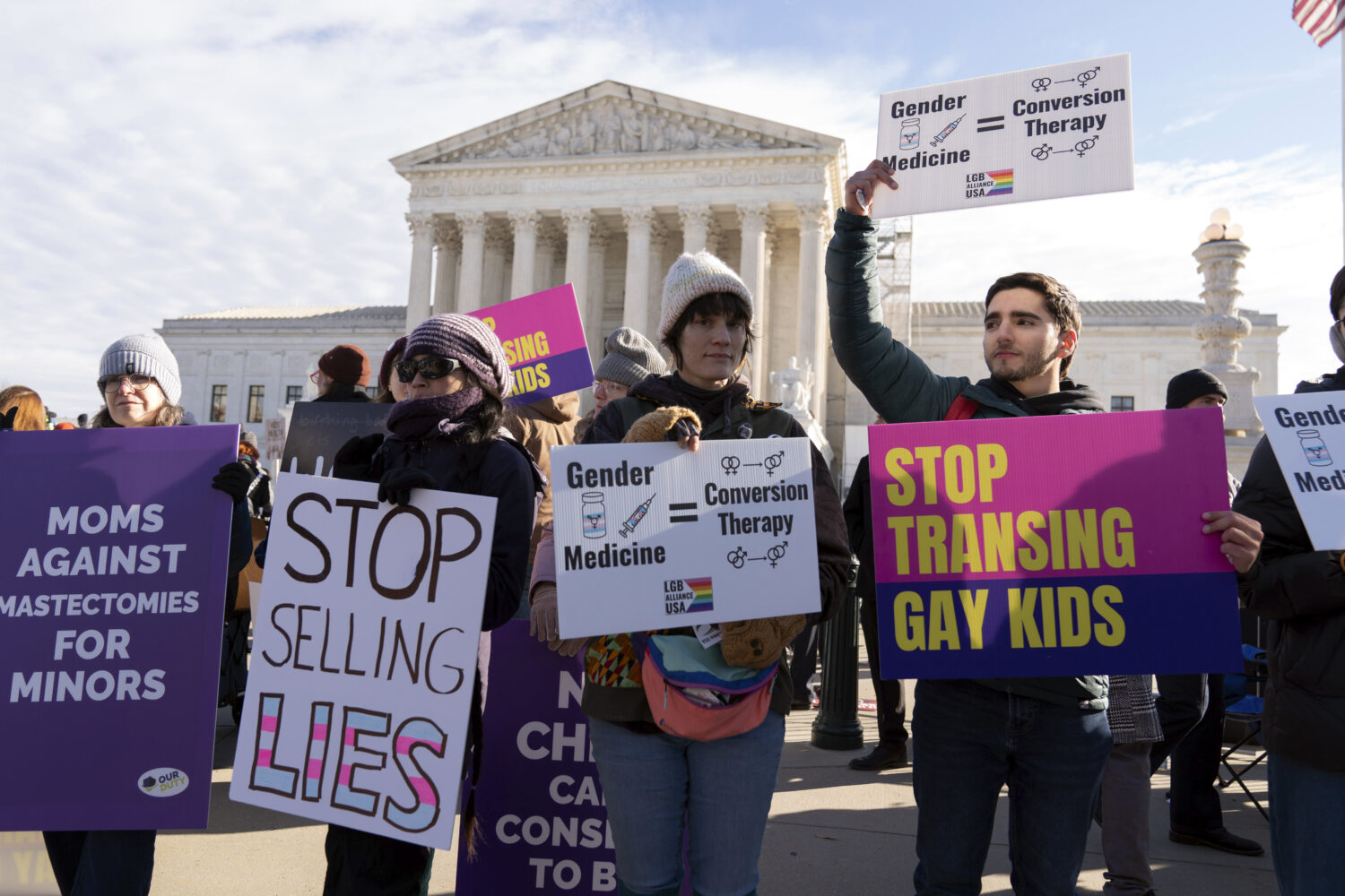 FILE - Demonstrators against transgenders rights protest during a rally outside of the Supreme Cour...
