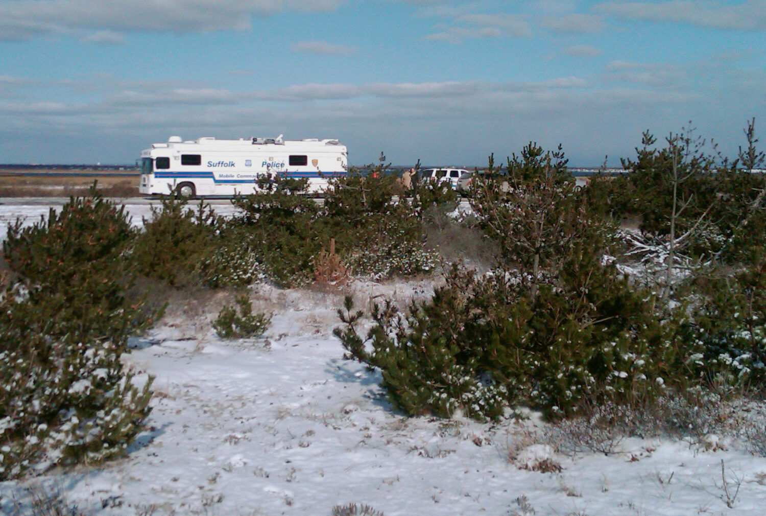 FILE - Suffolk County Police conduct a search, Tuesday, Dec. 14, 2010, along a beachfront road in B...
