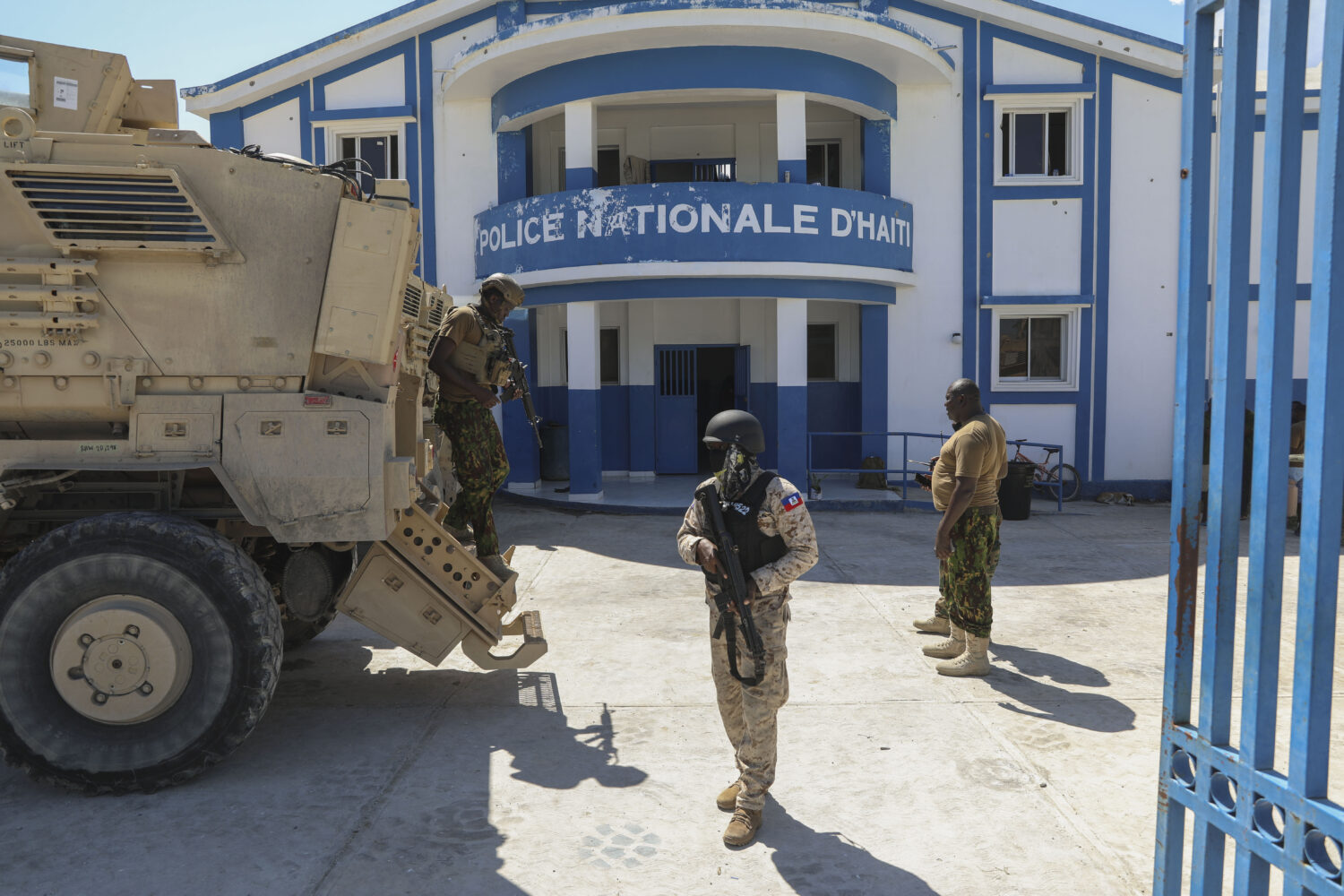 FILE - Haitian and Kenyan police who are part of a UN-backed multinational force stand at a police ...