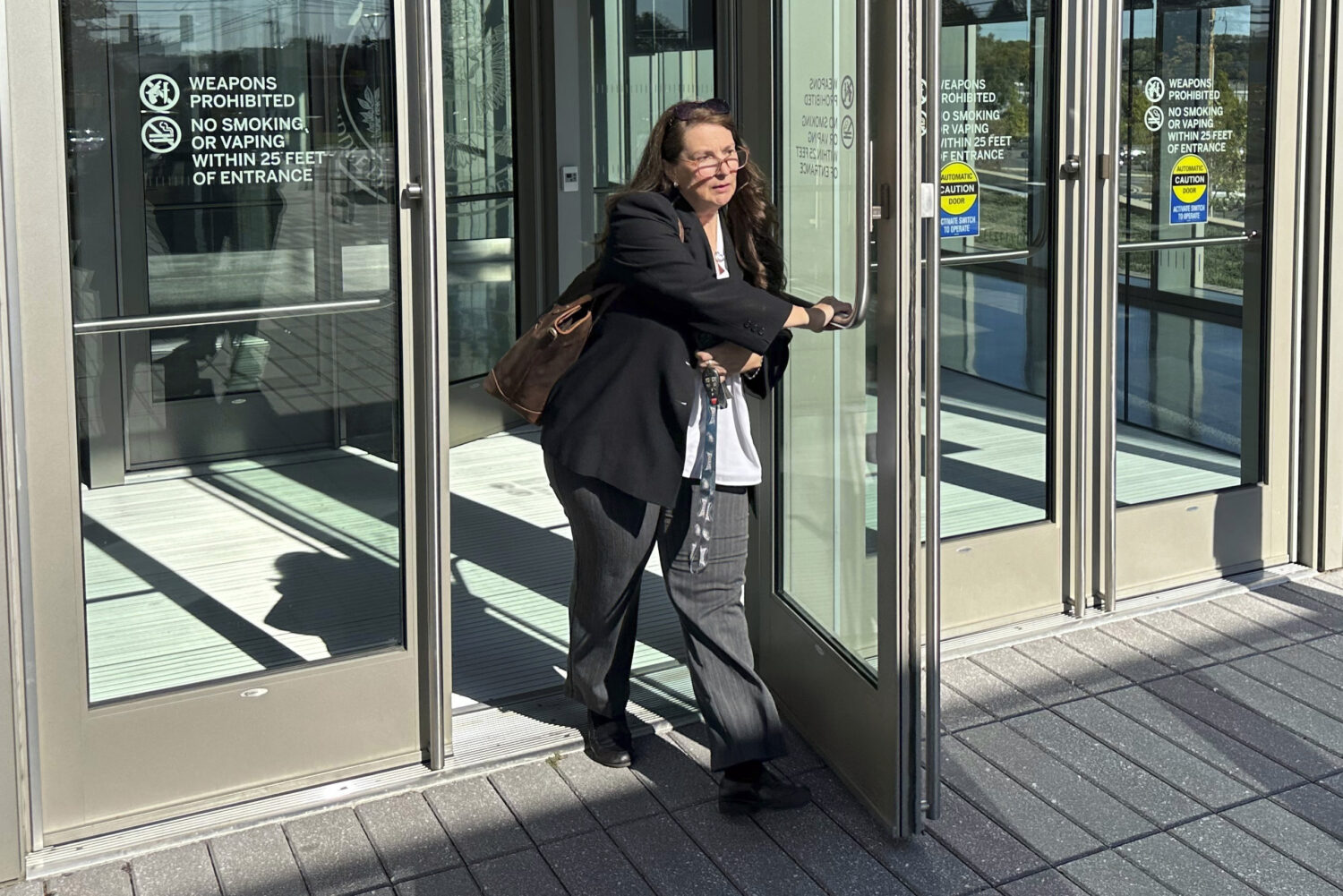 FILE - Heather Honey, a conservative election researcher, leaves the federal courthouse in Harrisbu...