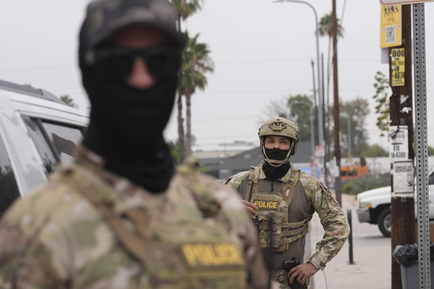 Federal agents stage outside a Home Depot during an operation Friday, Aug. 15, 2025, in Los Angeles...
