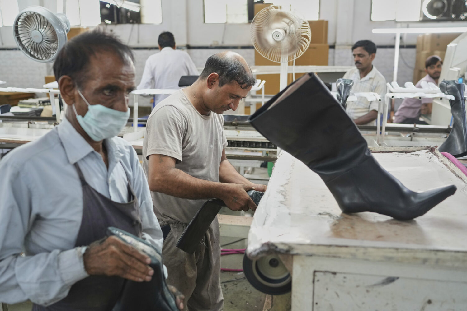 Workers in a manufacturing unit make leather footwear in Agra, India, Monday, Aug. 25, 2025. (AP Ph...