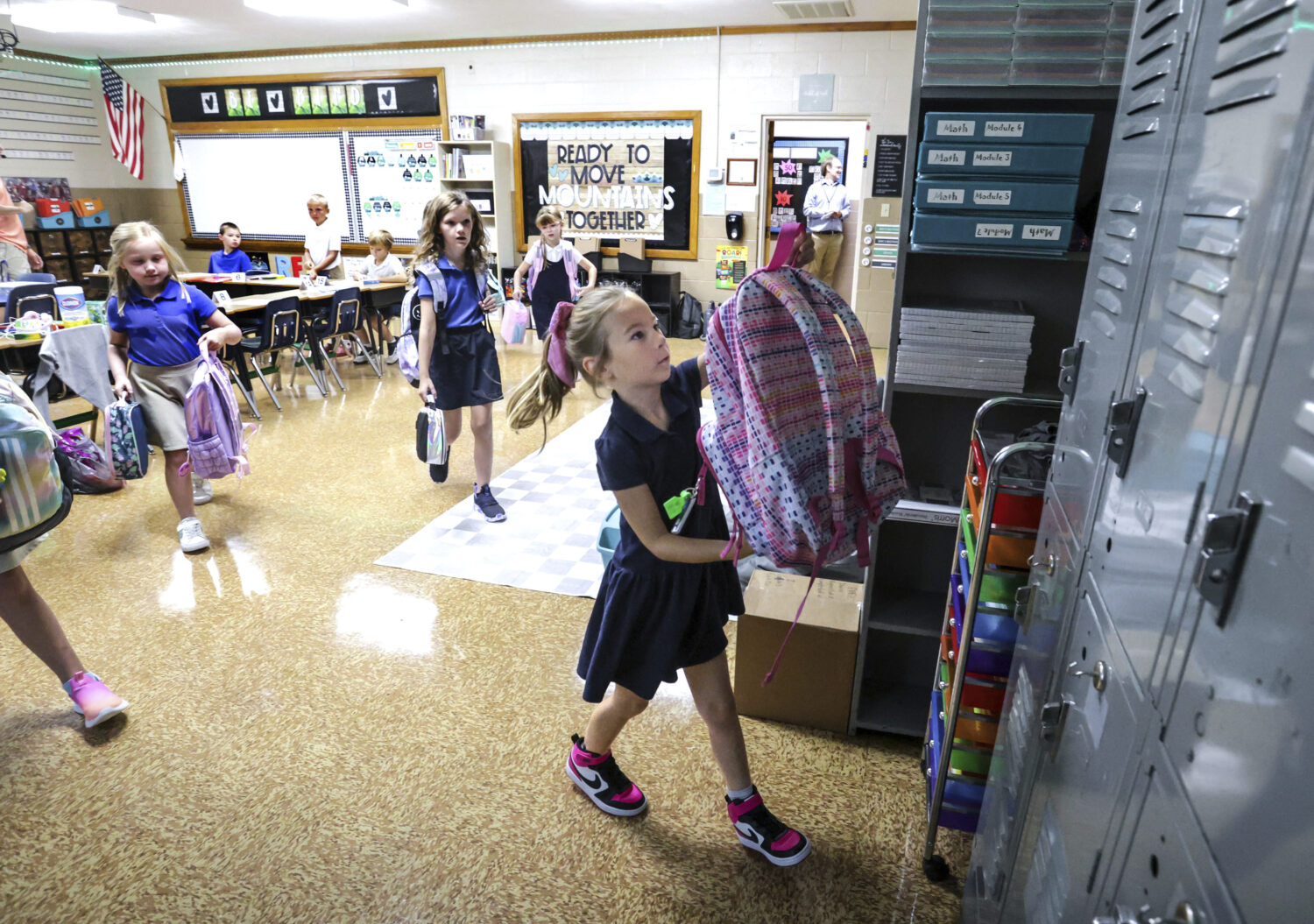 Savannah Knott hangs up her backpack for the day on the first day in her second grade classroom at ...