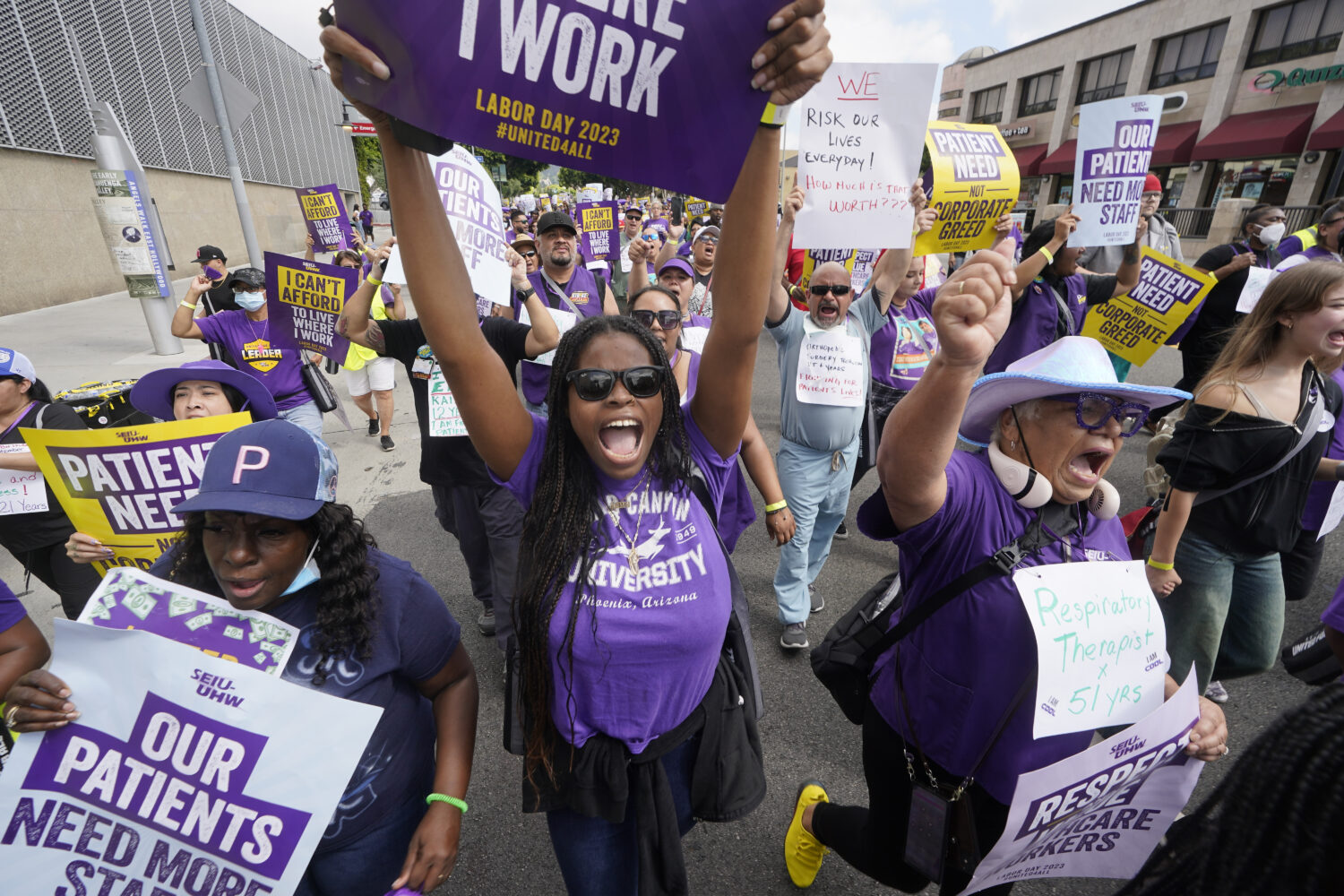 FILE - Frontline healthcare workers hold a demonstration on Labor Day outside Kaiser Permanente Los...