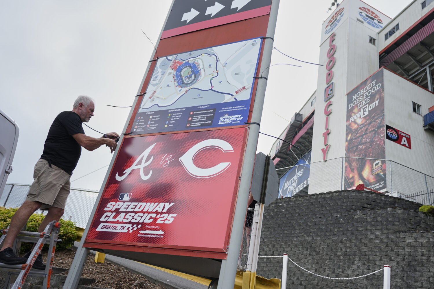 Rod Bruchell installs signs outside Bristol Motor Speedway, Friday, Aug. 1, 2025, in Bristol, Tenn....