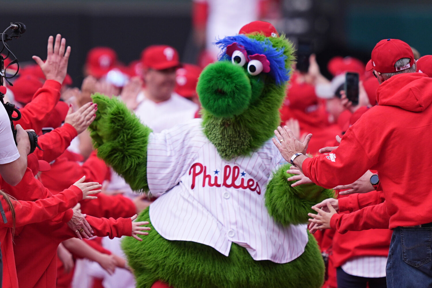 FILE - The Phillie Phanatic, the Philadelphia Phillies mascot, leads the team onto the field ahead ...