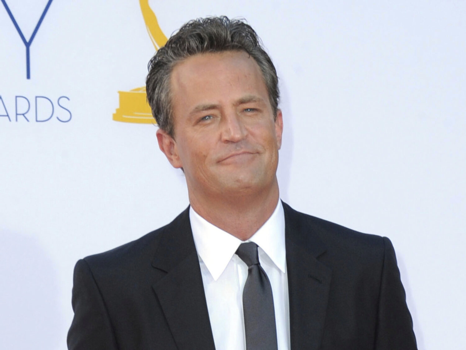 FILE - Actor Matthew Perry arrives at the 64th Primetime Emmy Awards in Los Angeles on Sept. 23, 20...