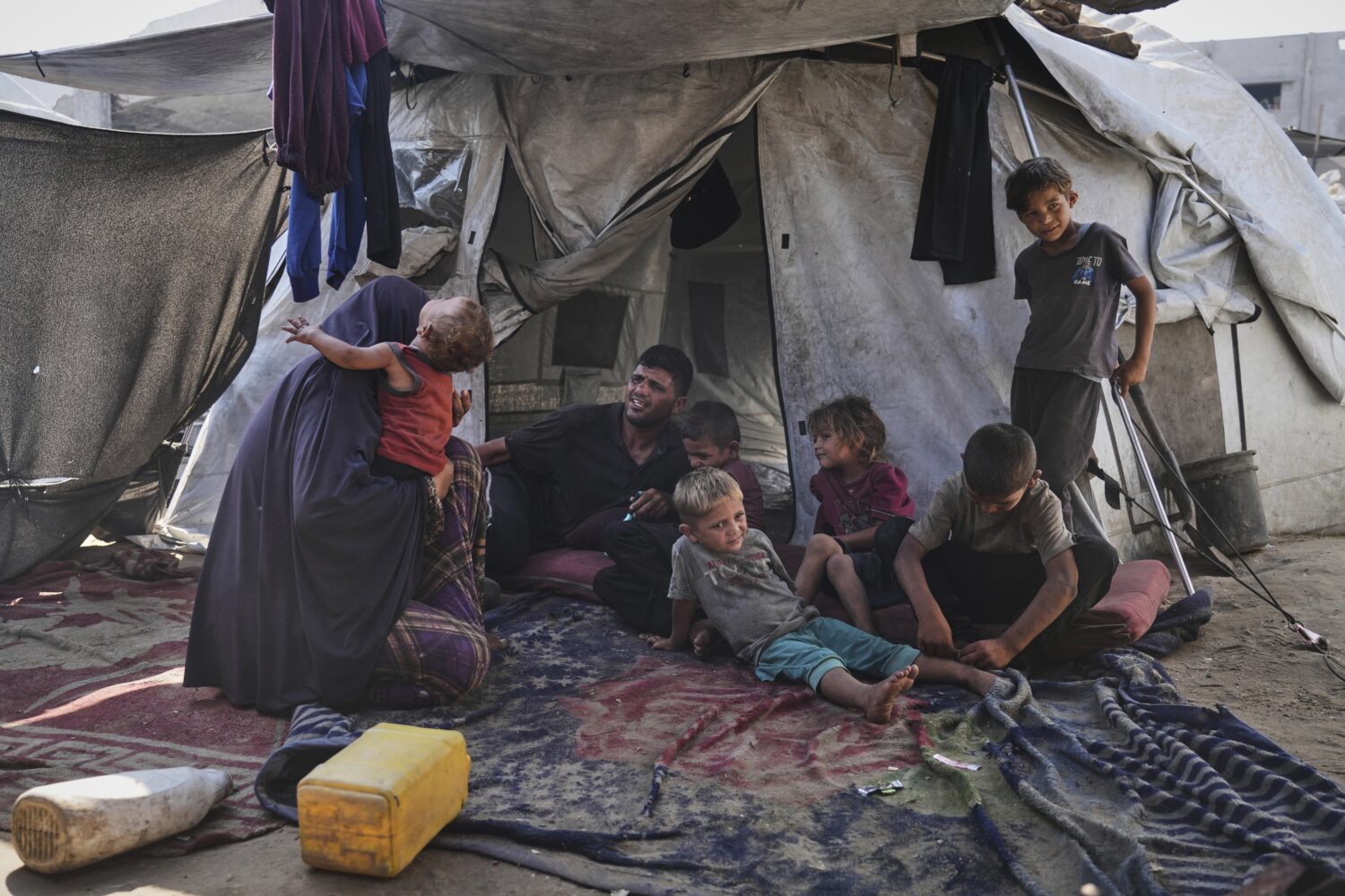 Abeer and Fadi Sobh gather in their tent with their children at a camp for displaced Palestinians i...