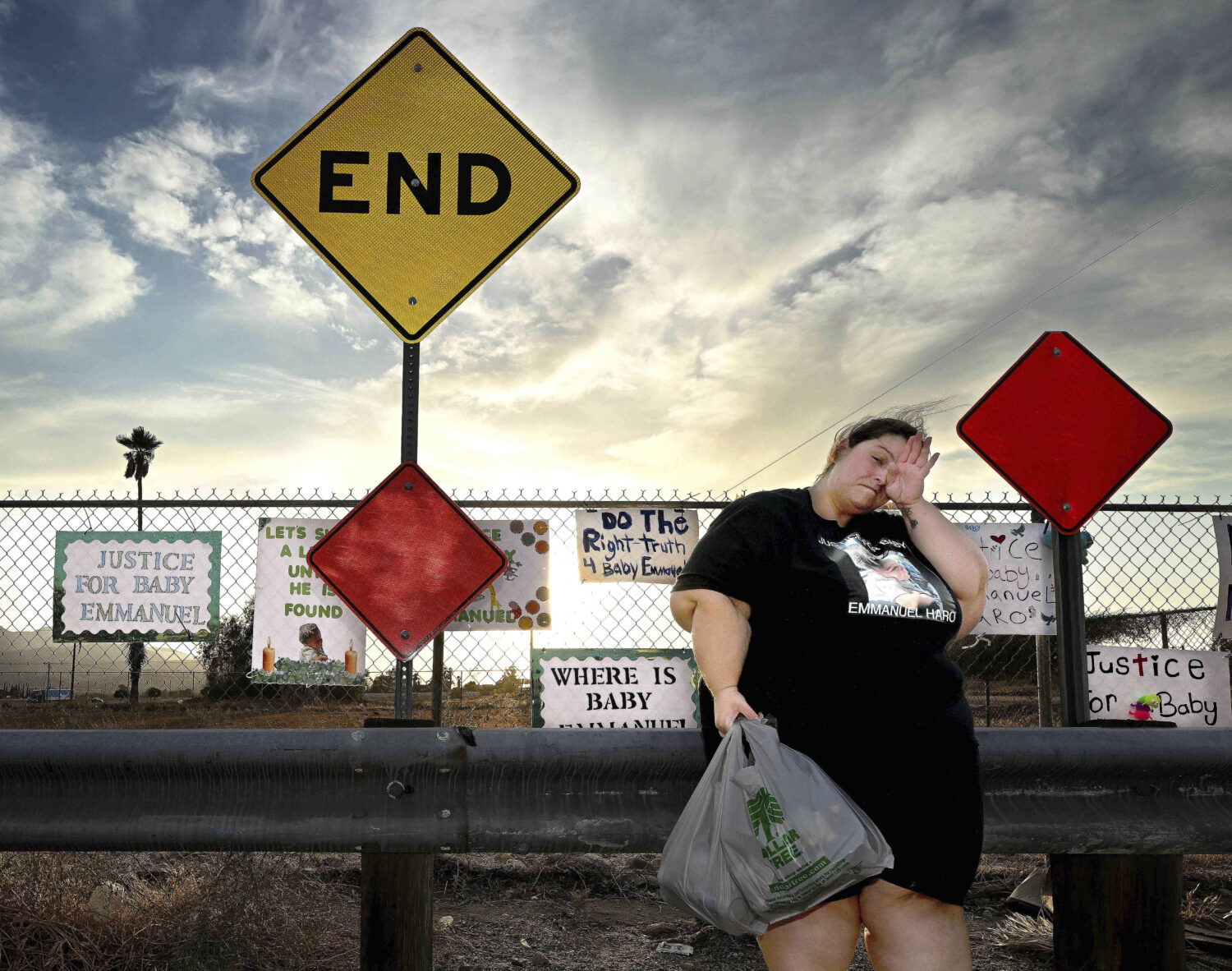 Arelene Sanchez-Turner, from Banning, wipes her eyes at a makeshift memorial prior to a vigil for m...
