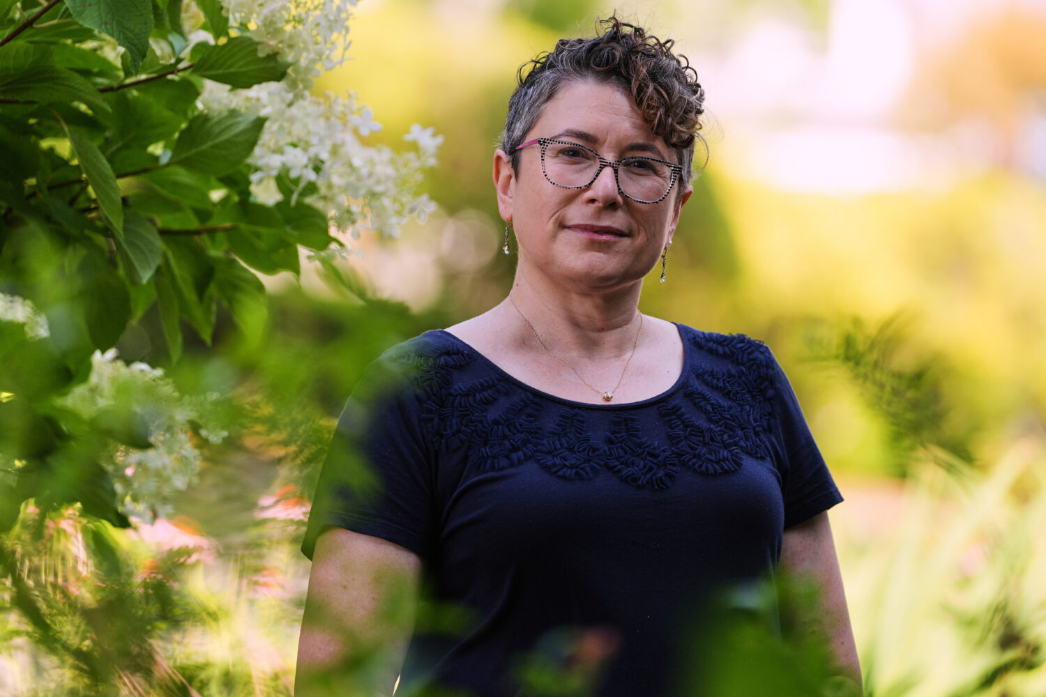 Ziva Mann, mother of a transgender child and member of a welcoming synagogue, poses in her garden, ...