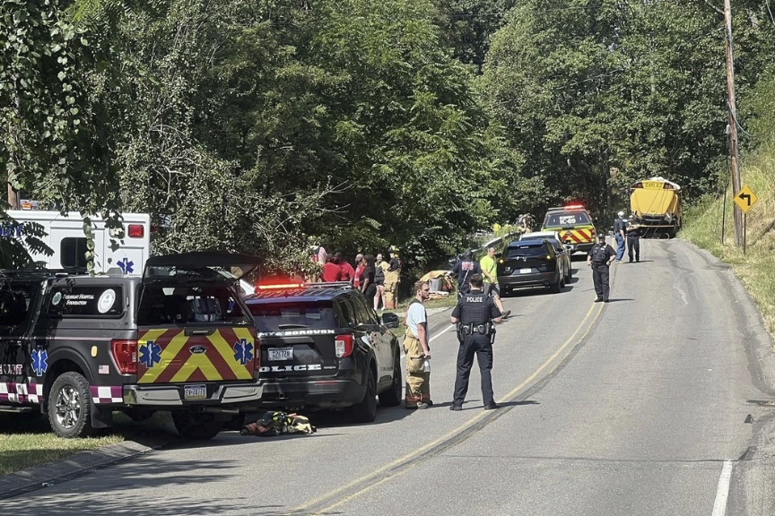 Emergency personnel work at the site of a crash of a bus carrying members of the Aliquippa Junior H...