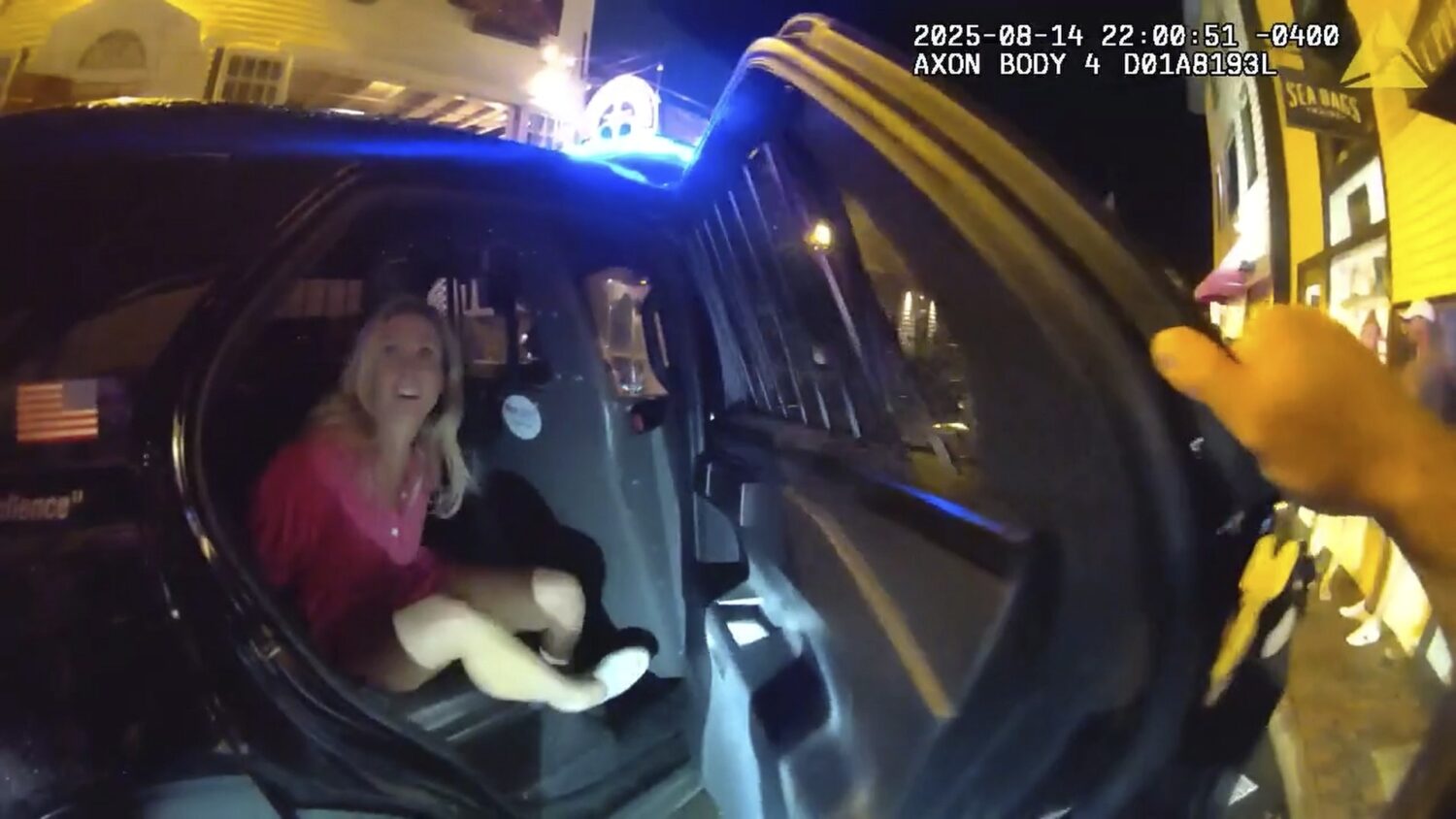 In an image taken from police body camera footage, a Newport Police officer closes the door of a cr...
