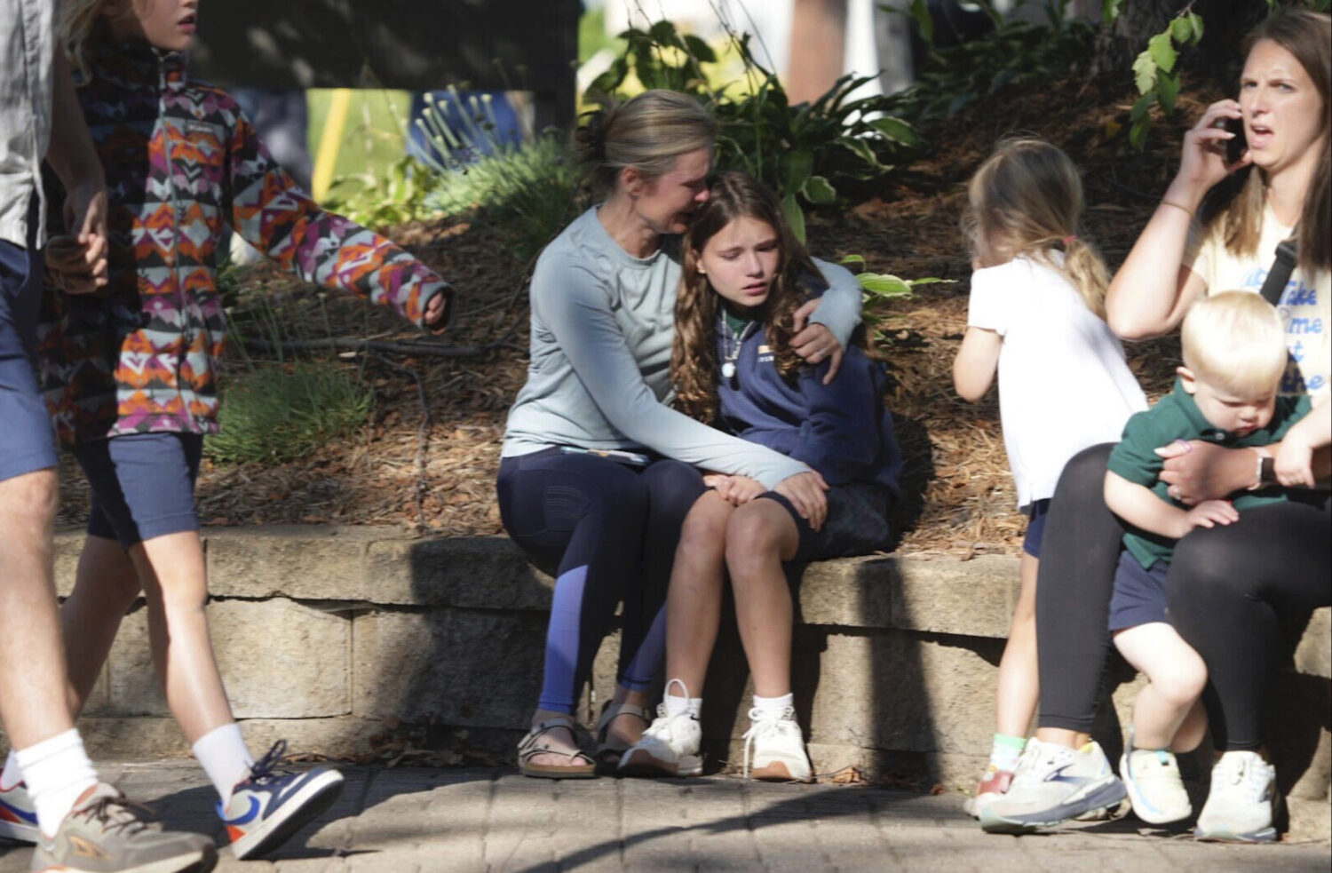Parents await news of their children's status after a shooting at Annunciation Church on Wednesday,...